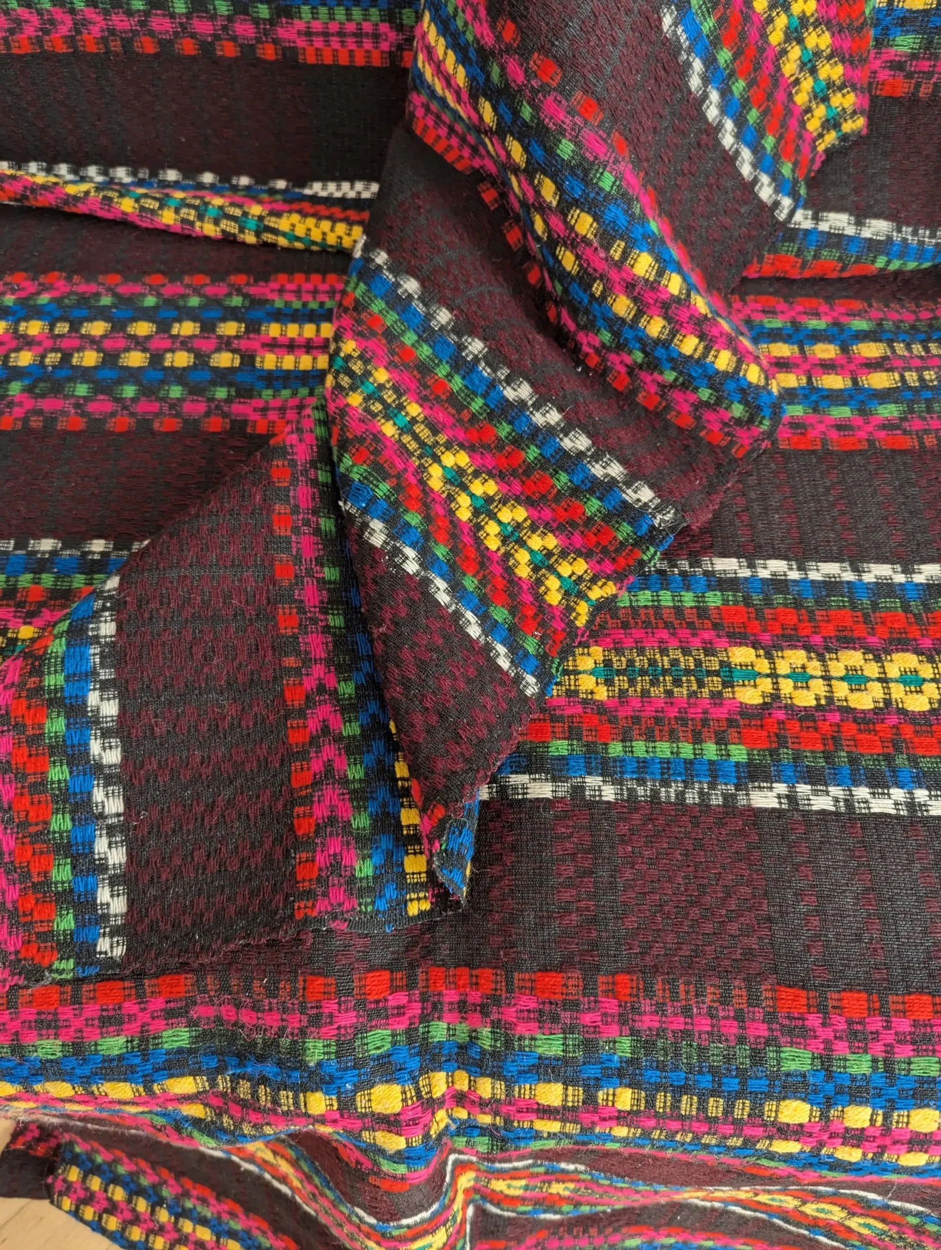A rainbow handmade vintage bedcover made on loom
